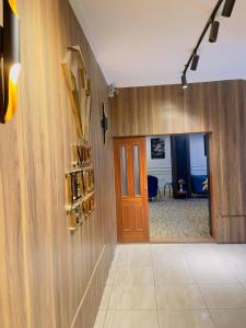 a hallway with a door to a room with wine bottles at Nile jewel hotel beni suef in Beni Suef