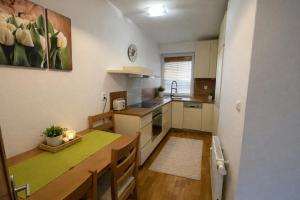 a kitchen with a table and a counter top at 3BR - City Views - Free Parking - Near Eurovea and Aupark in Petržalka
