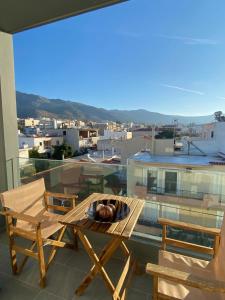 a table and chairs on a balcony with a view at Athinais Karystos in Karistos