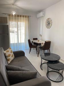 a living room with a couch and a table at Athinais Karystos in Karistos