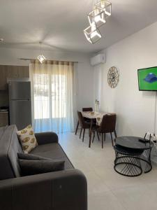 a living room with a couch and a table at Athinais Karystos in Karistos