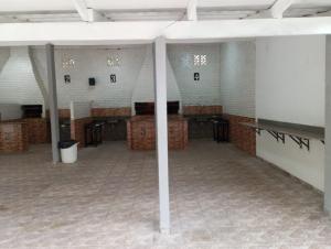 a large room with columns and tables in it at Refúgio das Thermas in Caldas Novas +14 photos