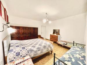 a bedroom with two beds and a dresser at L'ENCANTO DE LUNA -Una Casa Autentica Comacchiese in Comacchio