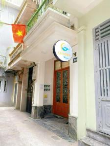 a sign on the side of a building with a red door at TV-Netflix STU 302 Near Uncle Ho's Mausoleum in Hanoi +4 photos