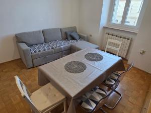 a living room with a table and a couch at Apartmaji Trije Valovi in Piran
