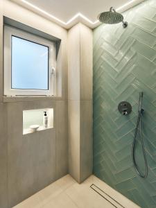 a bathroom with a shower with a glass door at Futura Hotel in Maleme