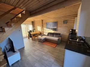 a living room with a couch and a table at Sosnowe Domki in Rewal