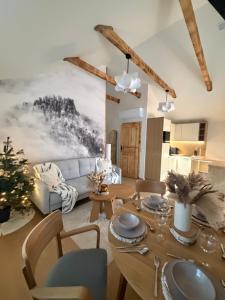 een woonkamer met een tafel en een bank bij Markowa Chata in Mizerna