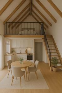 a kitchen and dining room with a table and a staircase at Luke & House in Śliwin