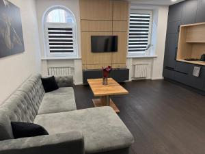 a living room with a couch and a table at Turgaus 10 in Klaipėda
