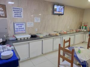 a kitchen with a counter with food on it at Estrela de davi in Goiânia