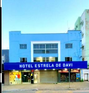 a blue building with a hotel estella de day sign on it at Estrela de davi in Goiânia