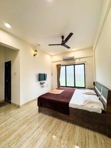 a bedroom with a large bed and a window at Horizon cottage in Nagaon