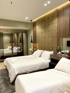 a hotel room with two beds and a mirror at Palma Pyramids hotel in Cairo