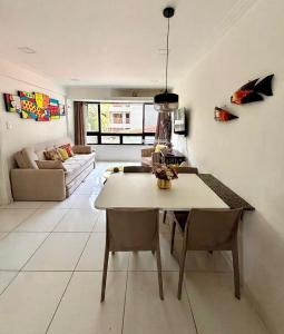 a kitchen and living room with a table and chairs at FLAT MAR E SOL 106 A 50m PRAIA in Porto De Galinhas +23 photos