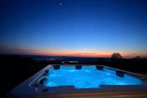 a jacuzzi tub with a sunset in the background at Zarnowa464 in Zarnowa