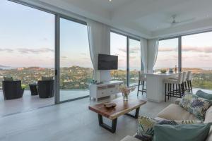 a living room with a couch and a table at Penthouse Residence 8 Suite 2 in Nathon Bay