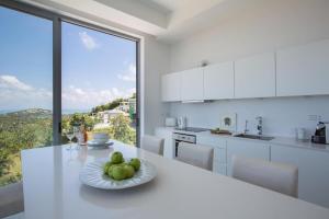 a kitchen with a table with a plate of fruit on it at Penthouse Residence 8 Suite 2 in Nathon Bay