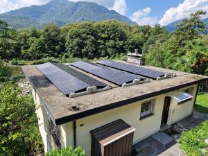 a group of solar panels on top of a roof at Casa Magging un oasi nel verde in Locarno
