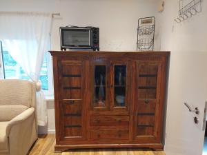 a wooden cabinet with a television on top of it at Ferienhaus Auszeit in Höchstädt an der Donau