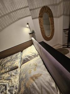 een slaapkamer met een bed en een spiegel bij Apartmán GREEN in Vysoké Mýto