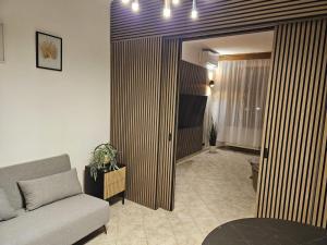 a living room with a couch and a table at Apartmán GREEN in Vysoké Mýto