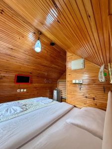 a bedroom with a large bed in a wooden wall at Isgobya Sumela Monastery 106 in Macka