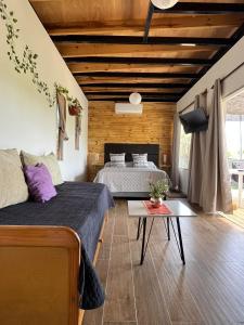 a bedroom with two beds and a table at Lofth house in Piriápolis