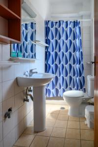 a bathroom with a sink and a toilet at Hotel Dimitra in Tsoukalaíika