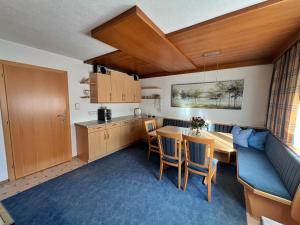 a kitchen and dining room with a table and chairs at Appart Leni in Pfunds