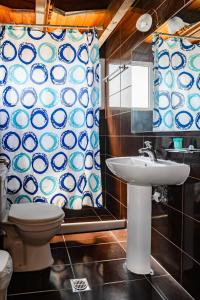 a bathroom with a toilet and a sink and a mirror at Hotel Dimitra in Tsoukalaíika