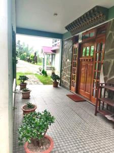 a porch with potted plants in front of a building at Vajrayogini Inn in Pedong