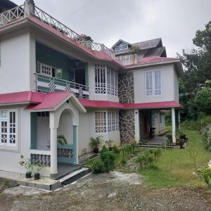 a house with a red roof at Vajrayogini Inn in Pedong