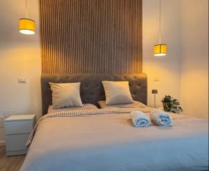 En eller flere senge i et værelse på MALAGO Apartment