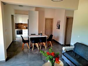 a kitchen and living room with a table and chairs at Andreas' Guest House in Káto Spílaion