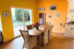 a dining room with a wooden table and chairs at Charming house with mountain view in Hämikon