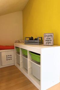 a room with a desk with green and white shelves at Charming house with mountain view in Hämikon