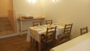 a dining room with a table and chairs in a room at Byrdir House in Harlech