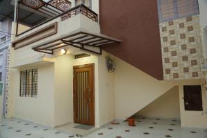 een huis met een bruine deur aan de zijkant bij ShivAOM Family Homestay in Ujjain