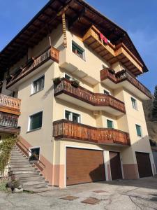 a large apartment building with balconies and a garage at Nido delle Dolomiti in Santo Stefano di Cadore