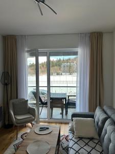 a living room with a couch and a table at Apartman MAD Bjelasnica in Bjelašnica