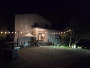 a building with a tent and lights at night at Aegviidu Mäe Maja in Aegviidu +9 photos
