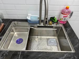 a sink in a kitchen with a dishwasher at Kuala Terla Cameron Cozy Home - Self Check-in in Kampung Kuala Terla