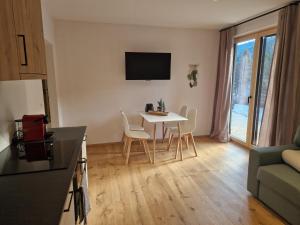 a small living room with a table and chairs at Haus Robi Wood in Bad Kleinkirchheim