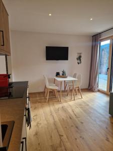 a dining room with a white table and chairs at Haus Robi Wood in Bad Kleinkirchheim +27 photos
