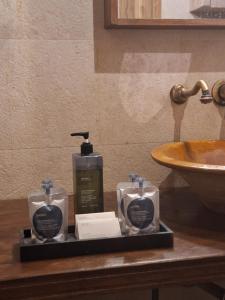 a bathroom with two bottles of soap and a sink at Baglio Giammaccaro in Castelluzzo +63 photos