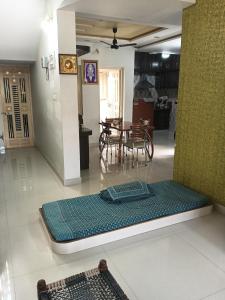 a mattress on the floor of a living room at Keshav in Bhuj