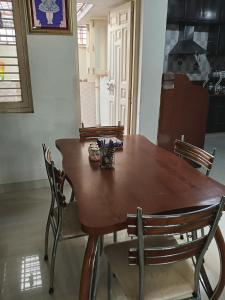a dining room table with chairs around it at Keshav in Bhuj