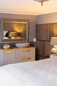 a bedroom with a bed and a mirror at Het Woonrijk in Bennekom +30 photos