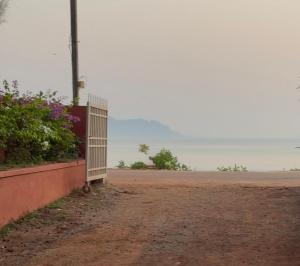 a fence on the side of a dirt road at Costa Rica in Kumta +4 photos